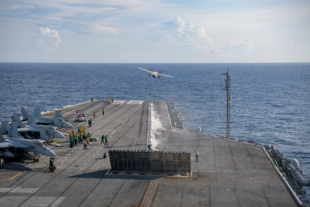 A C-2A Greyhound launches from USS Nimitz in June 2026 while steam trails across the flight deck.